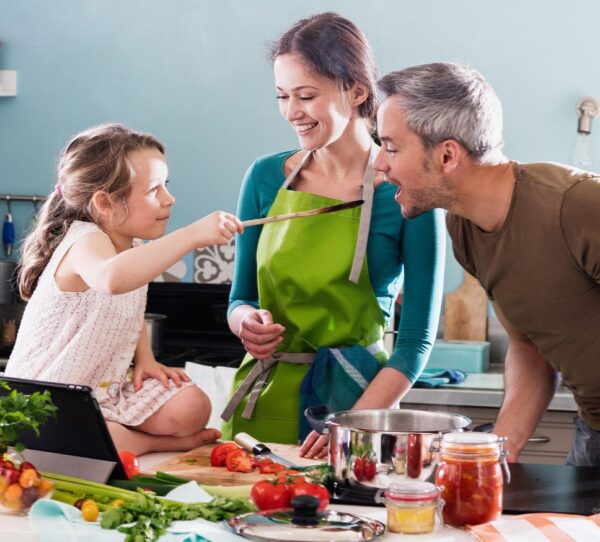 Financial Adviser Perth - Family in kitchen sharing a light moment showing care and togetherness
