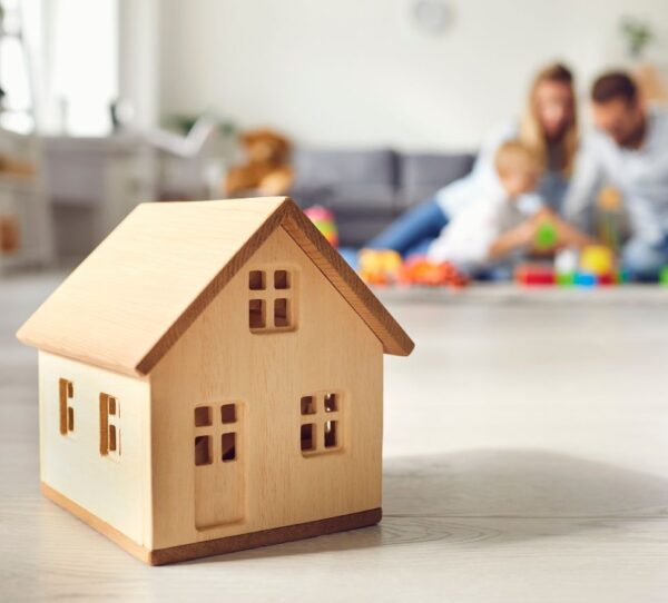Financial Adviser Perth - Family playing in background with house in focus showing security and future planning
