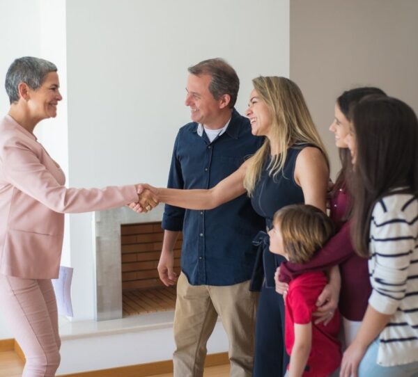 Financial Adviser Perth - Mom being congratulated with handshake and family beside her showing support achievement